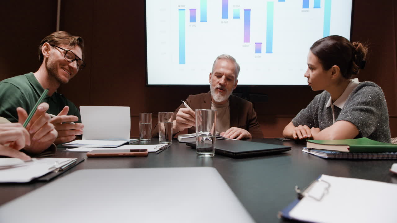 Business Professionals Discussing Data in a Meeting Room