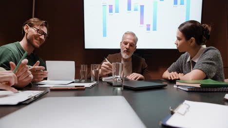 business professionals discussing data in a meeting room