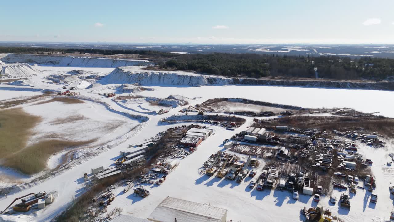 A snow-covered quarry with trucks and machinery, James Dick Quarry, Caledon, Ontario