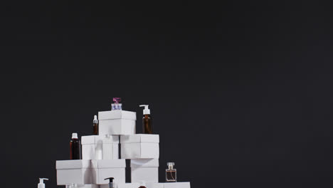 video of beauty products with white cardboard boxes with copy space over black background