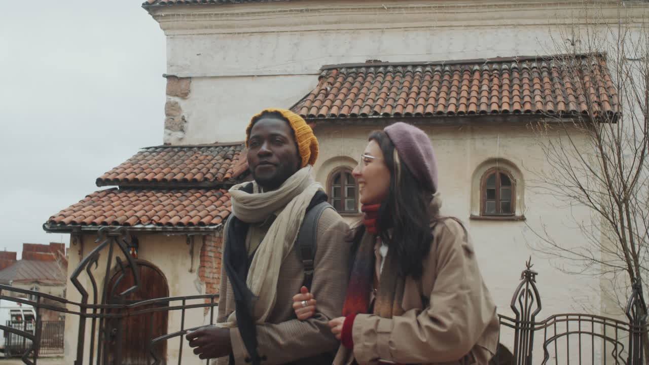Young Diverse Couple Walking in Old Town