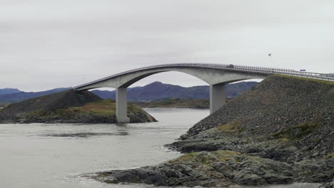 atlantic ocean road in norway - a curved bridge spanning above scenic waters, connecting islands - handheld shot