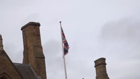 close up of union jack flying in the wind on cloudy day