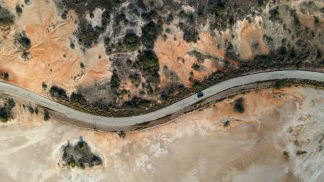 Drone-shot-showing-the-aerial-view-of-a-highway-along-the-coast-of-Porlamar,-located-in-Margarita-Island-in-the-country-of-Venezuela