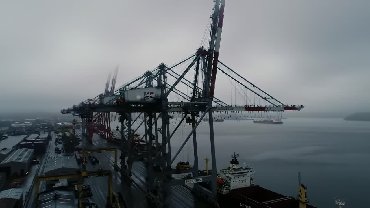 Port Scene Amidst Fog: Towering Cranes and Shipping Vessels in a Misty Maritime Environment Symbolizing Industrial Activity and Transportation Dynamics