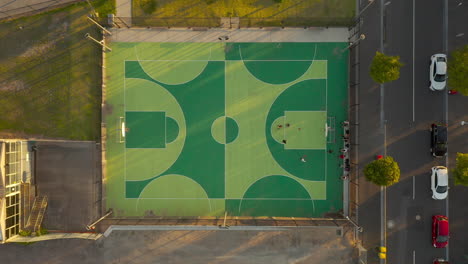 local basketball team practicing shooting hoops on outdoor basketball court