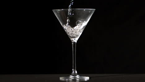 water pouring into cocktail glass