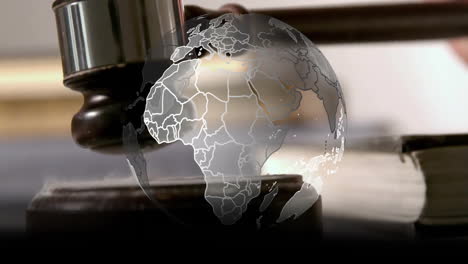 animation of spinning globe over hand using gavel