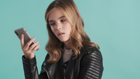 Teenage-Caucasian-girl-holding-smartphone-near-her-ear.