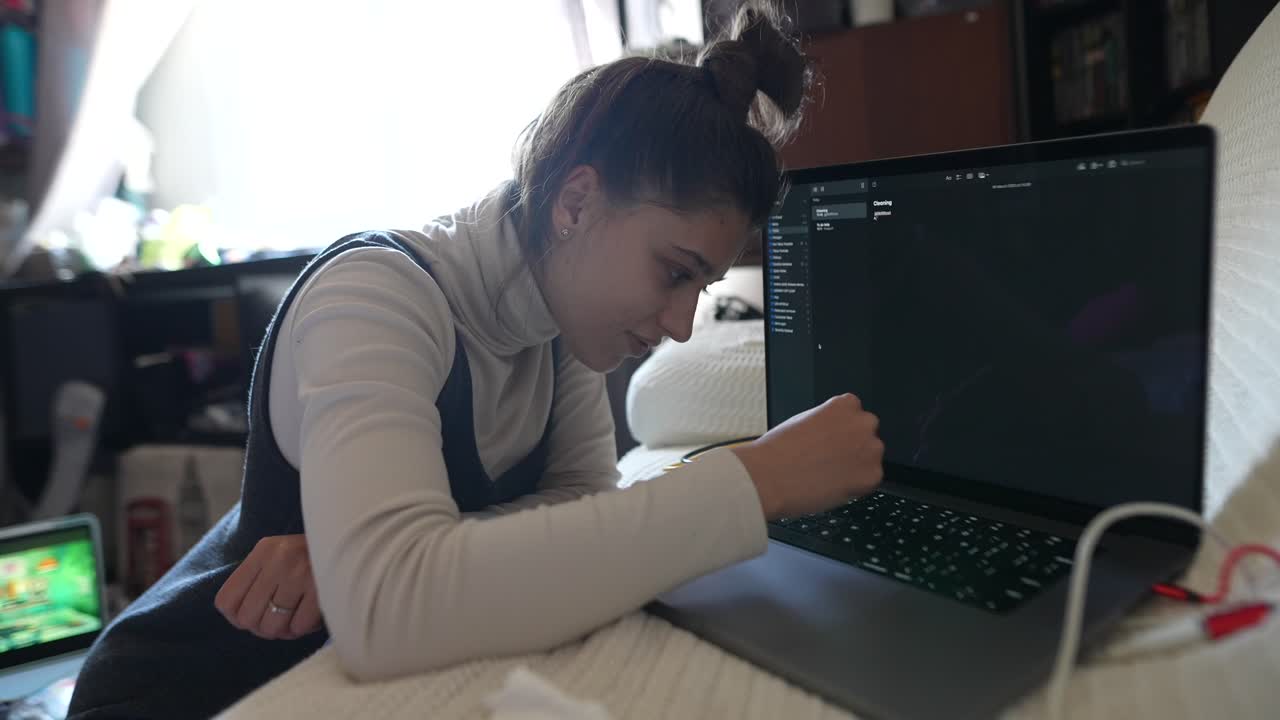 Young Woman Working on Laptop at Home