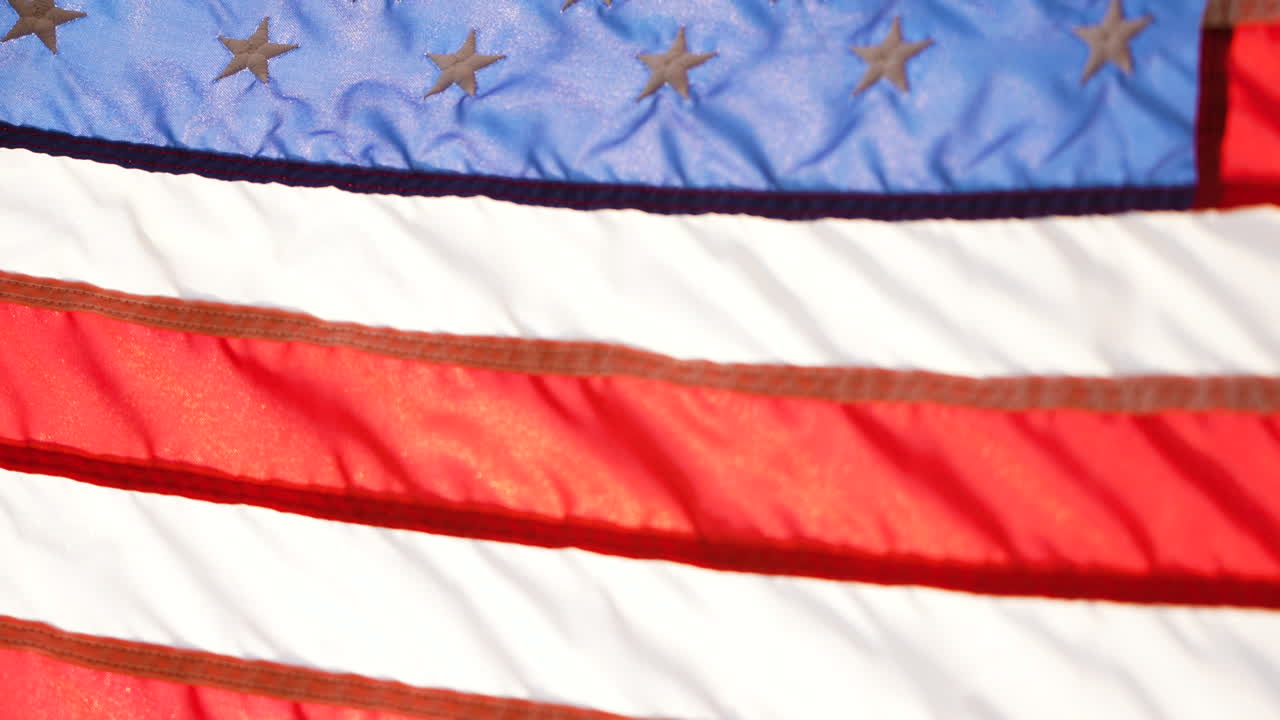 Slow motion close-up shot of the American flag flying in the wind
