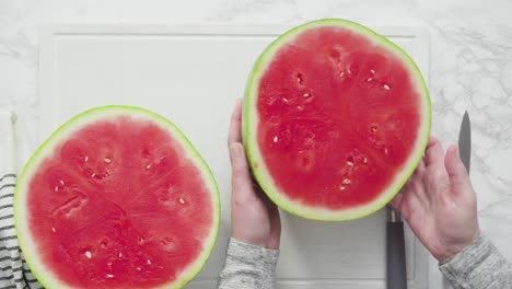 slicing red watermelon into small pieces