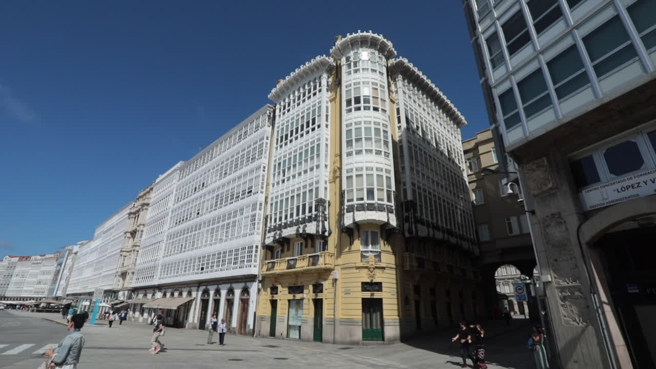 A sunny street view of classic European buildings with intricate windows and historic architecture