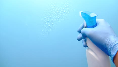 cleaning with spray bottle and gloves