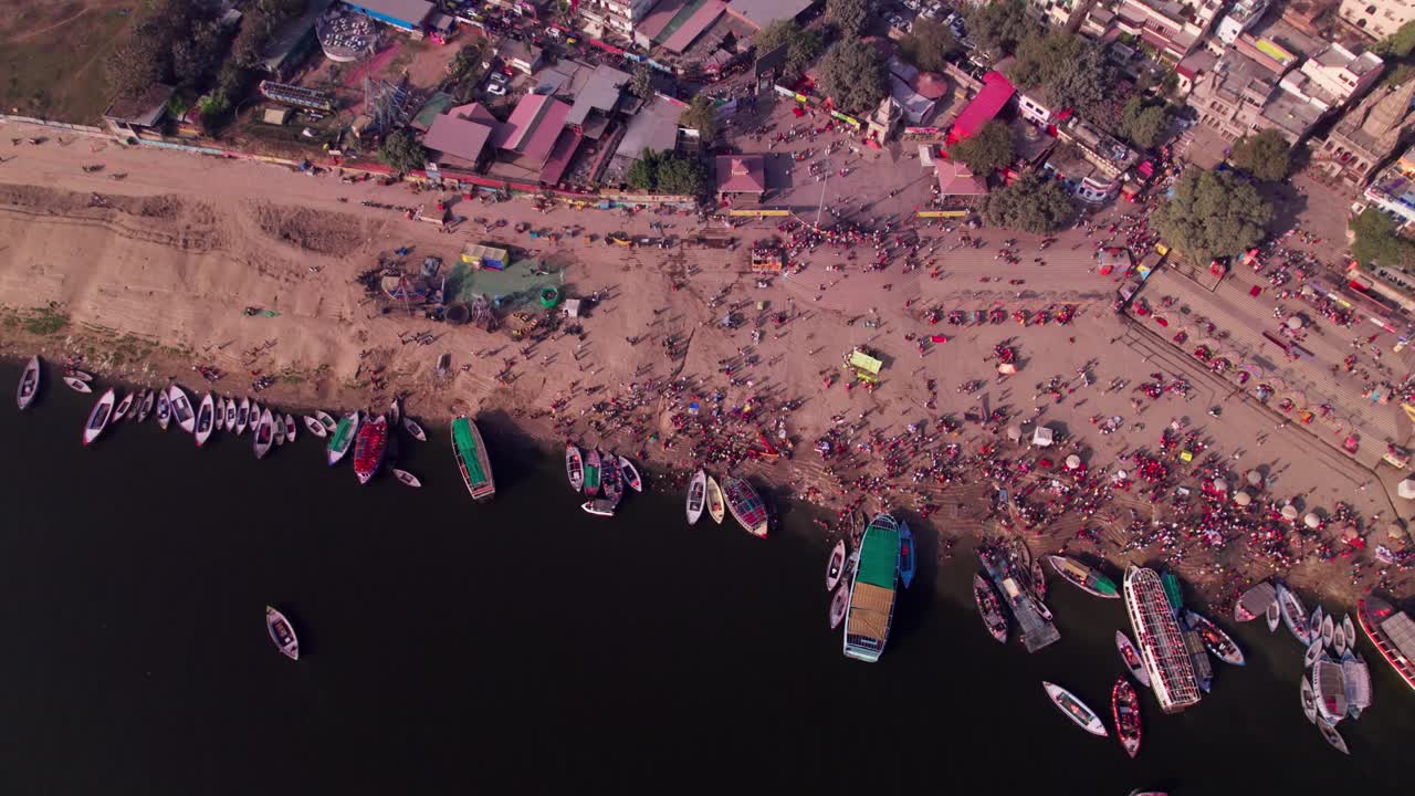 Top down view of assi ghat with gang river and boats at varanasi, kashi, uttar pradesh, india. day time, stable shot, drone shot, 4k.