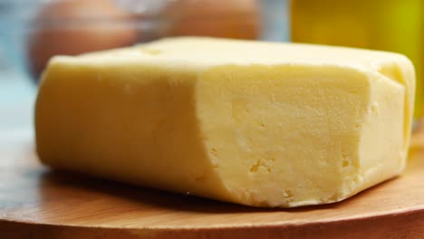 rebanada de mantequilla y pan de harina entera en la tabla de cortar