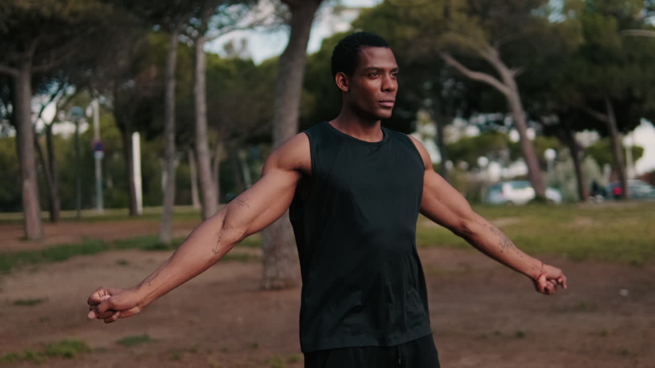 Muscular Man Stretching in Park for Fitness Workout
