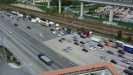 many cars stopping to pay for roads in modern highway, aerial view