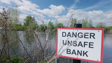 danger unsafe bank, warning sign on river waveney