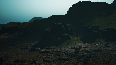 a mountain landscape with a rocky peak and a lush green valley