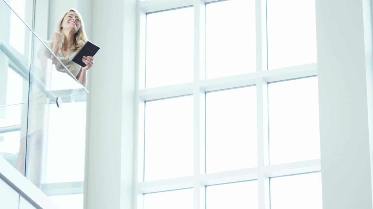 mujer de negocios caucásica usando una tableta inalámbrica en la oficina de la ciudad