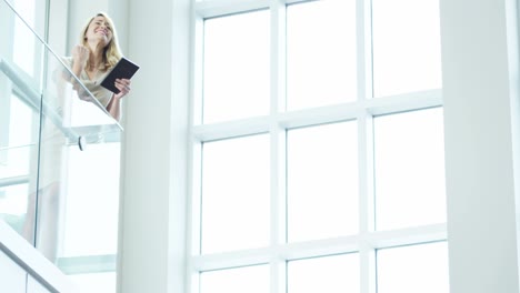 caucasian businesswoman using wireless tablet in city office