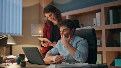 coworkers talking online meeting at evening office. man video calling laptop