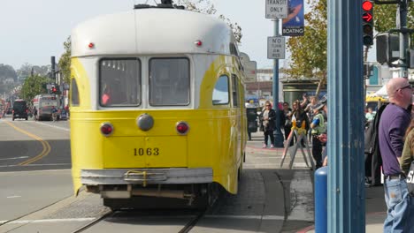 san francisco tram passing busy sidewalk