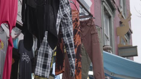 Close-Up-Of-Clothes-Hanging-Outside-Shops-On-Camden-High-Street-In-North-London-UK