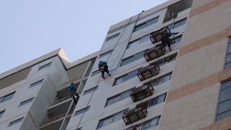 worker on scaffold performing maintenance on high-rise