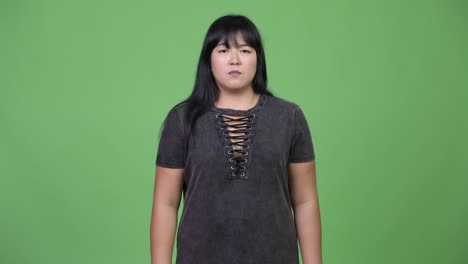 beautiful overweight asian woman giving thumbs up