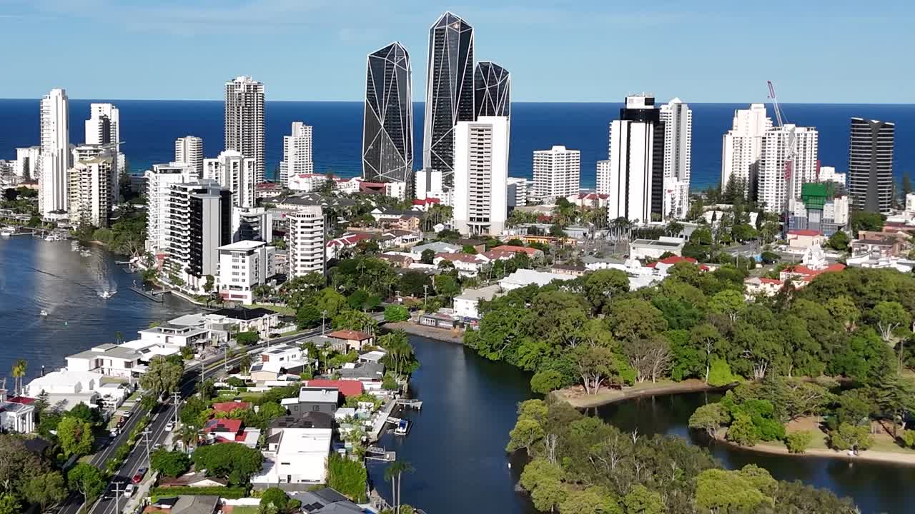 Cropped aerial footage showcasing a vibrant city skyline with lush greenery and winding waterways.