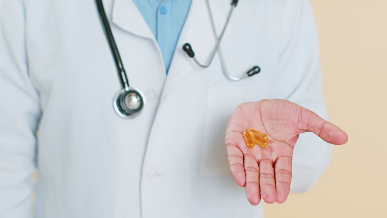el médico muestra píldoras de omega-3 en la palma de la mano recomienda medicamentos tratamiento de inmunización de vitaminas