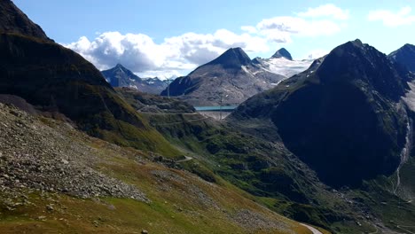 slow aerial dolly shot over a rocky alpine stream with glacial water crashing over lightly coloured, heavily eroded rocks