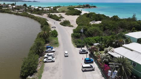 vehicle driving on coastal road in antigua - aerial drone shot