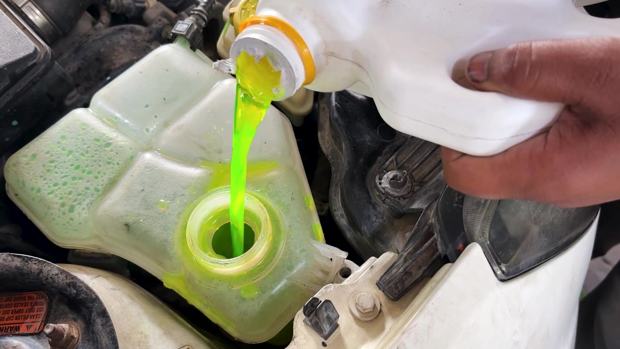 Close Up Of Green Engine Coolant Filling Car Coolant Reservoir During Service