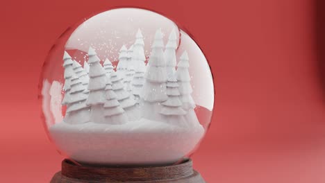 verzauberter winterwald in einer schneekugel auf rotem hintergrund