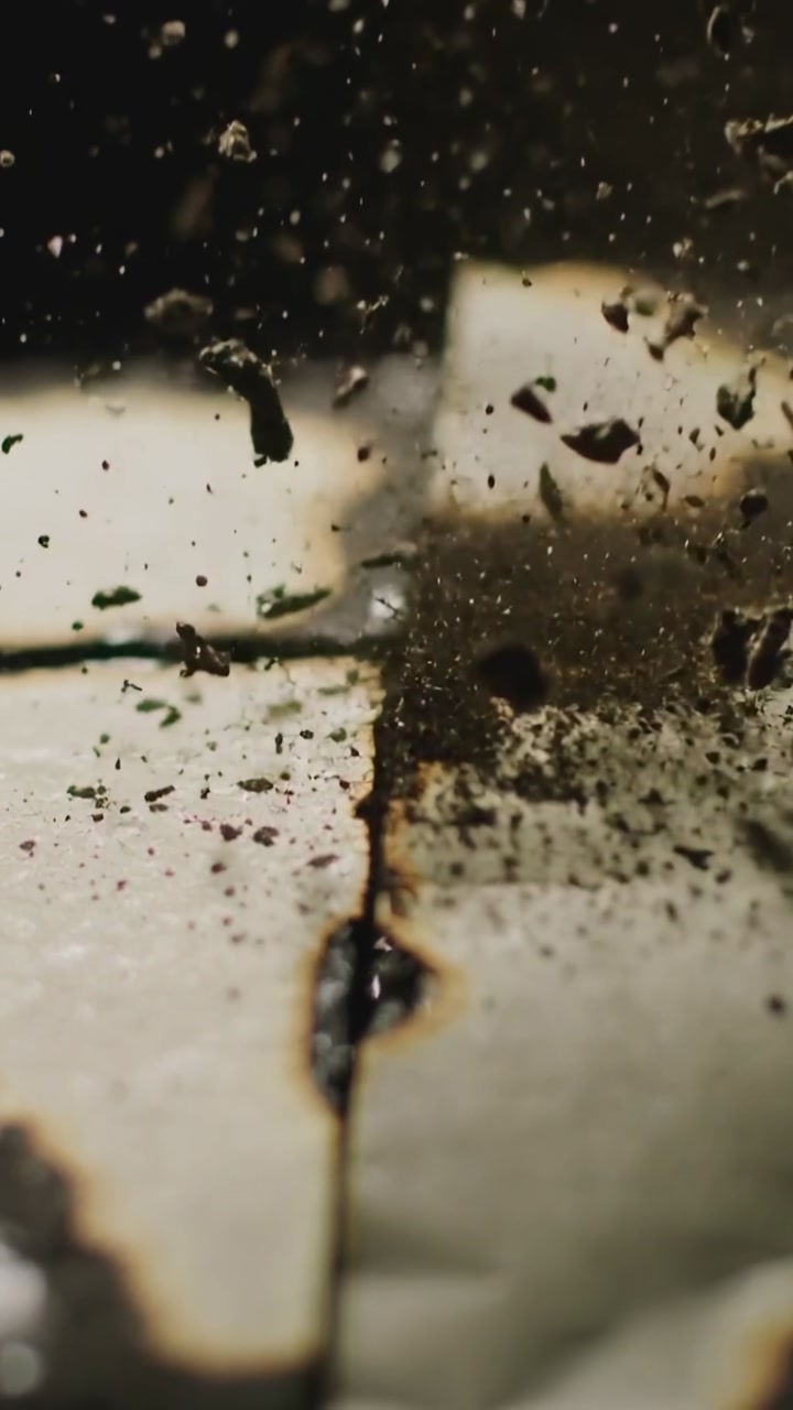 Close-up of Ash and Debris Falling onto a Burnt Surface