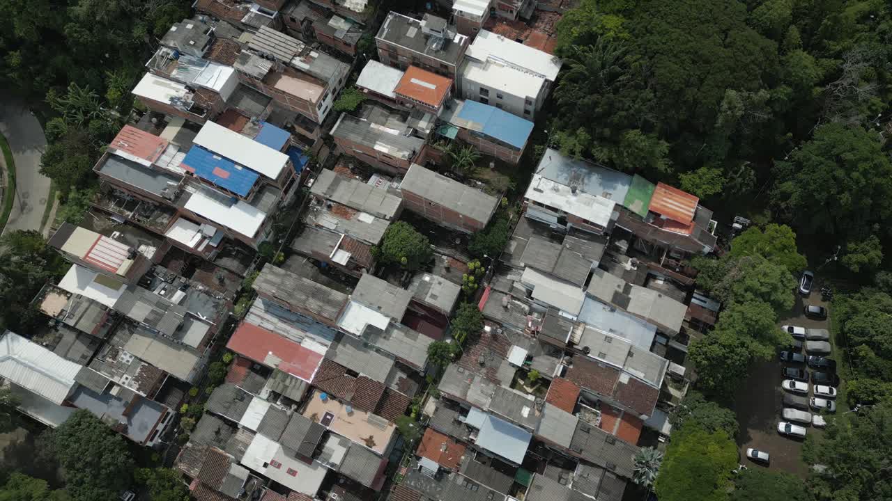 Drone video, bird's eye view of roofs of houses in Aguacatal neighborhood, western Cali, Colombia
