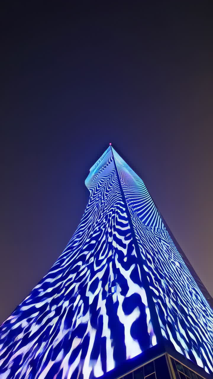 Modern skyscraper at night with illuminated facade