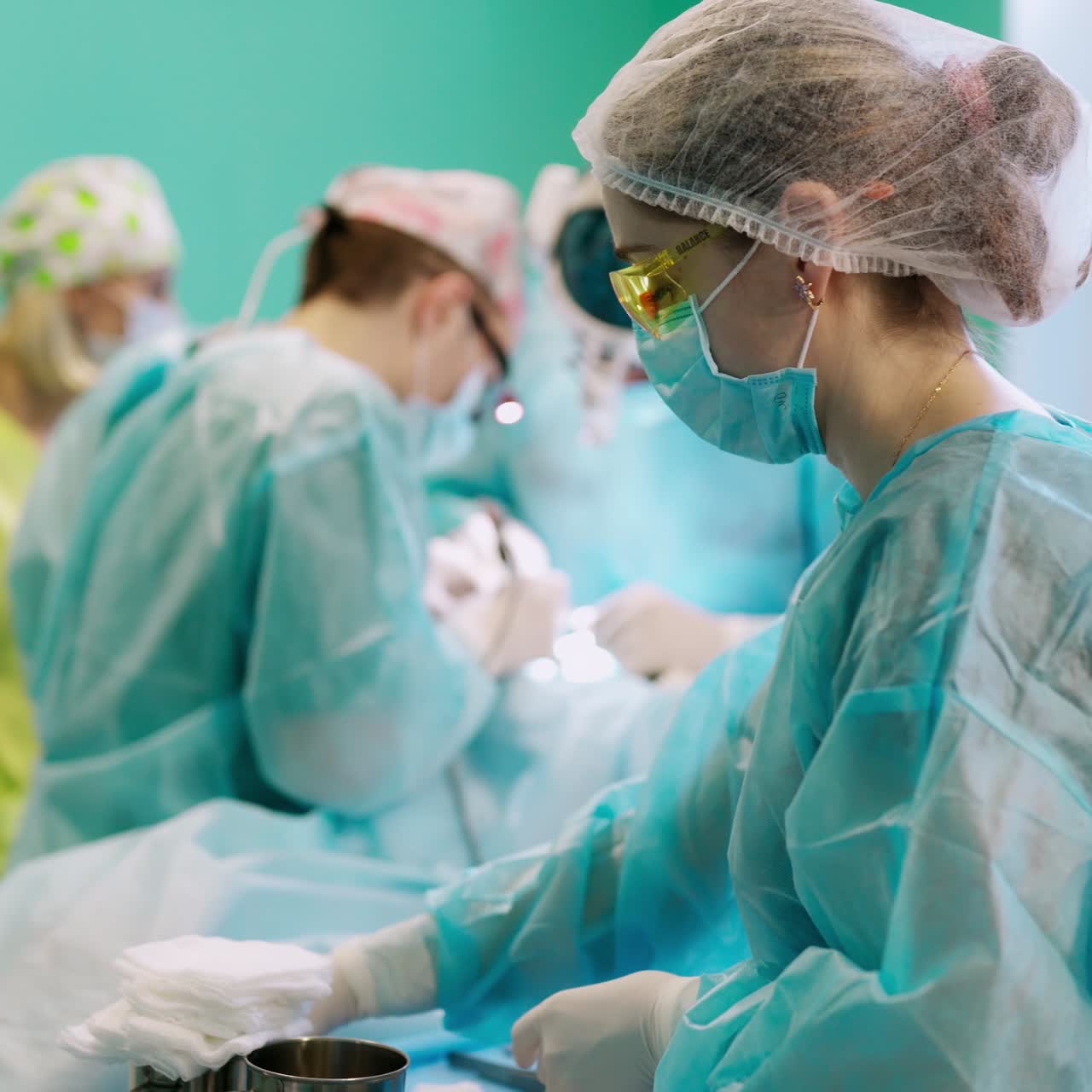 Modern hospital operating theater. Team of surgeons perform delicate operation
