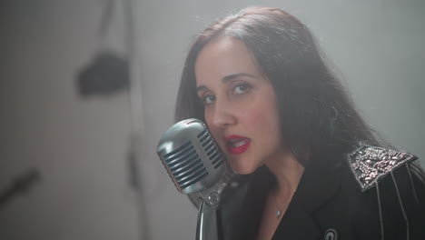 close-up of a passionate female vocalist with red lips singing and snapping fingers, set against a blurred background, emphasizing her intense performance