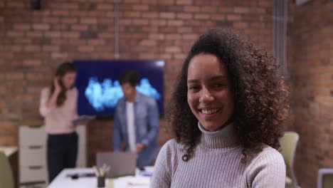 Creative-businesswoman-smiling-in-modern-office