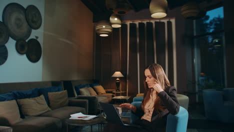 business woman using laptop computer for online video call in office lounge