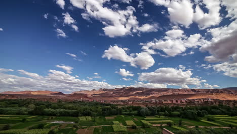 timelapse of rural village landscape with hill terrain and agriculture field