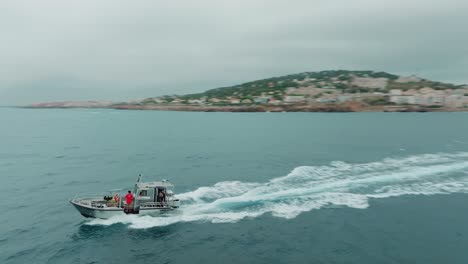 Orbital-view-using-the-drone-of-a-scientific-ship-sailing-in-the-waters-off-the-coast-of-Sete,-Herault,-France