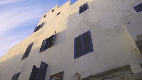 whitewashed building with blue windows