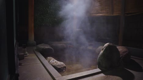 japanese hot spring, geothermal steam rising from rotenburo onsen