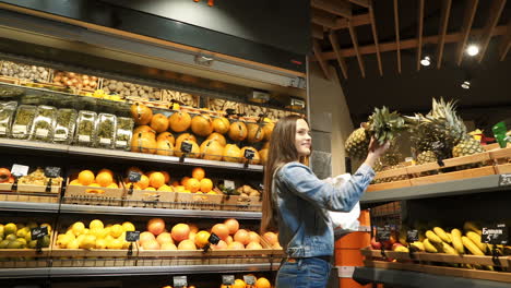 girl at the shopping center choosing fruits and vegetables hands fresh red apple. healthy eating. raw food. diet.