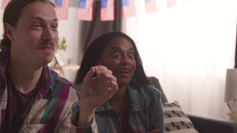 Woman-At-Home-Serving-Cupcakes-With-Miniature-American-Stars-And-Stripes-Flags-To-Friends-At-Party-Celebrating-4th-July-Independence-Day-3